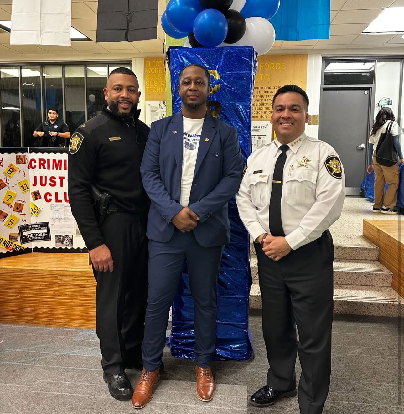 Program instructor with two sheriff's office officers at the Career Fair 25-26